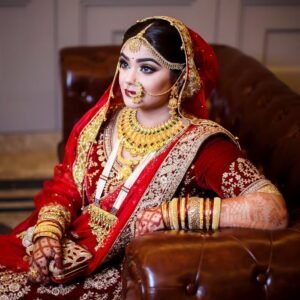 Woman in Red Sari Dress Siting on Sofa