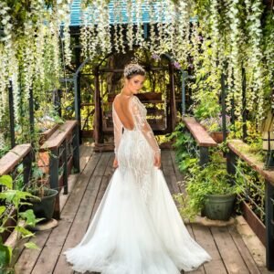 Woman in White Wedding Gown Standing on Brown Wooden Pathway